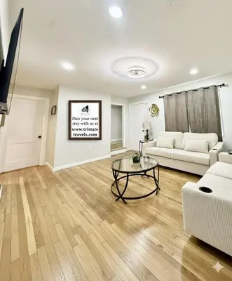a living room with a white couch and a table at Historic Barn View Modern Country Newton House in Newton