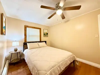a bedroom with a bed and a ceiling fan at Country Comfort Cabin Delaware River Islands in Montague
