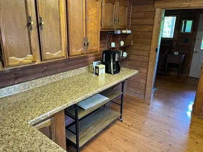 a kitchen with a counter with a coffee maker on it at Starboat Log Home in Jersey Shore