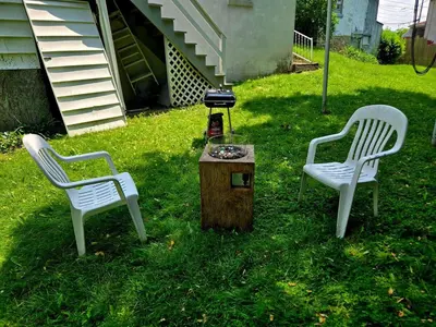 two chairs and a table with a grill in a yard at NEW 