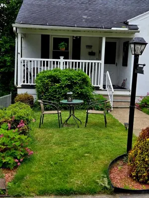 a house with two chairs and a table in the yard at NEW 