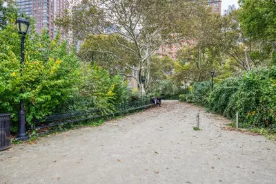 a dirt path in a park with trees and bushes at Blueground Financial District rooftop nr Brooklyn Bridge NYC-1971 in New York