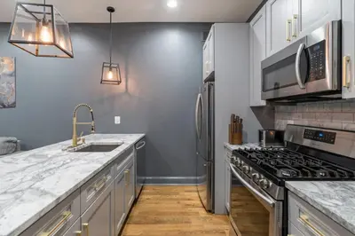 a kitchen with a sink and a stove at Brewerytown Luxurious Home Movie theater in Philadelphia