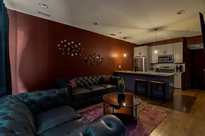 a living room with a couch and a kitchen at Brewerytown Luxurious Home Movie theater in Philadelphia