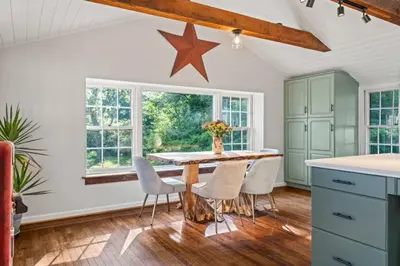 a kitchen with a table with chairs and a star on the wall at New Pristine Suburban Escape in Newtown Square