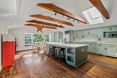 a kitchen with green cabinets and a red refrigerator at New Pristine Suburban Escape in Newtown Square