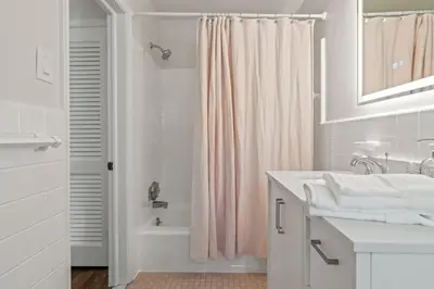 a bathroom with a sink and a shower curtain at New Pristine Suburban Escape in Newtown Square