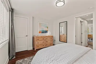 a white bedroom with a bed and a dresser at Washington Square West in Philadelphia