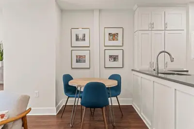 a kitchen with a wooden table and blue chairs at Washington Square West in Philadelphia