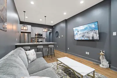 a living room with a couch and a kitchen at Chic Urban Oasis Movie Theatre in Philadelphia