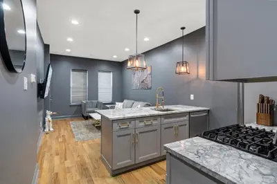 a kitchen with a sink and a stove at Chic Urban Oasis Movie Theatre in Philadelphia