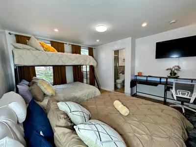 a bedroom with two bunk beds and a couch at BP STAYS - Hotel-Style, No Host, Professionally Managed ID260 in Jersey City