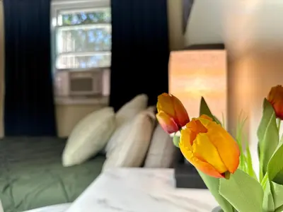a vase with flowers on a table in a room at BP STAYS - Hotel-Style, No Host, Professionally Managed ID260 in Jersey City