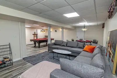 a living room with a couch and a pool table at Heated Private Pool Hot Tub Game Room Sauna in Stroudsburg