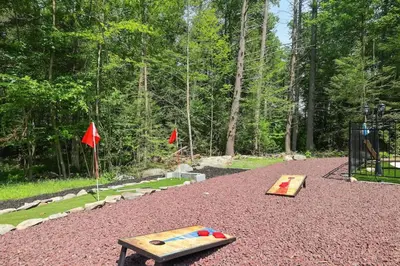 a play area with a wooden table and a playground at Heated Private Pool Hot Tub Game Room Sauna in Stroudsburg