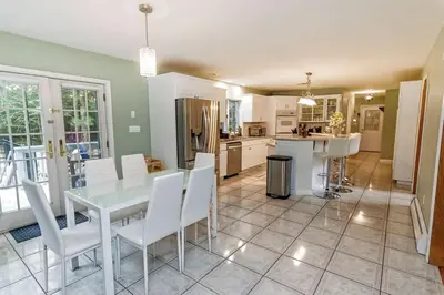 a kitchen with a white table and white chairs at Heated Private Pool Hot Tub Game Room Sauna in Stroudsburg