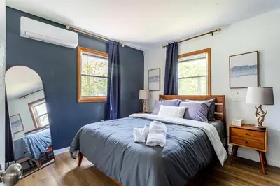 a blue bedroom with a bed with towels on it at Blue Diamond Hot Tub Fire Pit 3 BDR in Tobyhanna