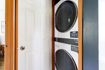 a washer and dryer in a room next to a door at Blue Diamond Hot Tub Fire Pit 3 BDR in Tobyhanna