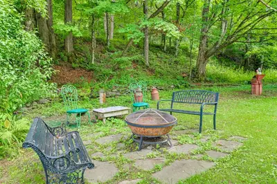a group of benches and a fire pit in a park at Hike and Fish Delaware River Cabin with Views in East Branch