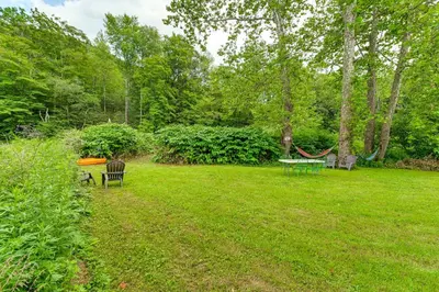 a yard with two benches and a hammock at Hike and Fish Delaware River Cabin with Views in East Branch