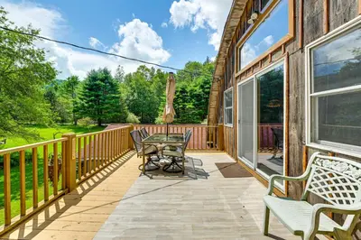 a patio with a table and chairs on a balcony at Hike and Fish Delaware River Cabin with Views in East Branch