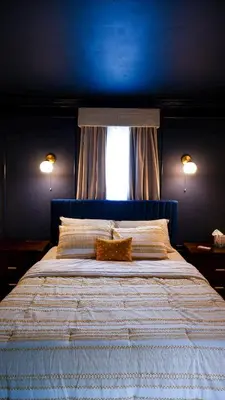 a blue bedroom with a large bed with a window at Morristown Charm in Morristown