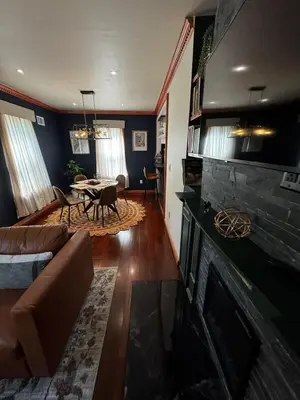 a living room with a couch and a fireplace at Morristown Charm in Morristown