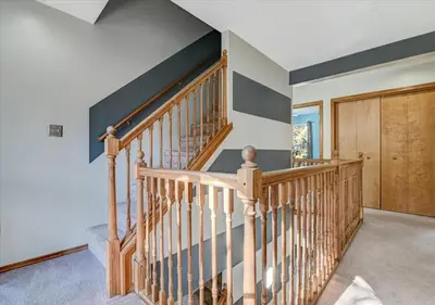 a wooden staircase in a home with a wooden door at Lakefront Kayaks, HotTub FirePit Sauna Pool in East Stroudsburg