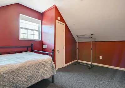 a bedroom with a bed and a red wall at Lakefront Kayaks, HotTub FirePit Sauna Pool in East Stroudsburg