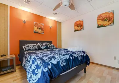 a bedroom with a blue and white bed in a room at Lakefront Kayaks, HotTub FirePit Sauna Pool in East Stroudsburg