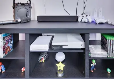 a table with a shelf with toys on it at Hot tub - Game Loft & Arcade - 2 King Beds - Pet Friendly in Tobyhanna