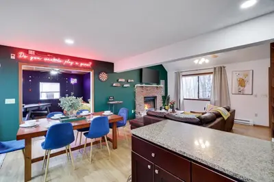 a kitchen and living room with a table and chairs at Hot tub - Game Loft & Arcade - 2 King Beds - Pet Friendly in Tobyhanna