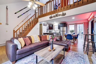 a living room with a couch and a table at Hot tub - Game Loft & Arcade - 2 King Beds - Pet Friendly in Tobyhanna
