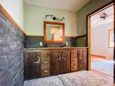 a bathroom with a sink and a mirror at Hidden River Lodge at Hawk Mountain
