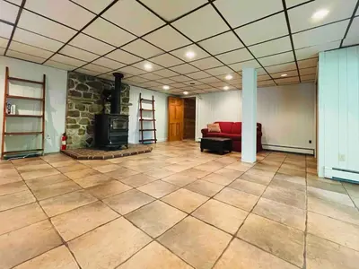 a large living room with a fireplace and a couch at Hidden River Lodge at Hawk Mountain