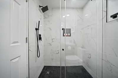 a bathroom with a shower with a glass door at Newly renovated luxury 3BR Condo! 30 mins to NYC in Jersey City