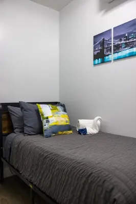 a bedroom with a bed with a picture on the wall at Newly renovated luxury 3BR Condo! 30 mins to NYC in Jersey City