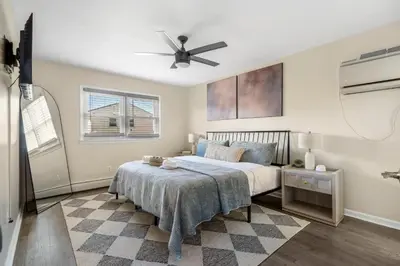 a bedroom with a bed and a ceiling fan at Modern 3BR Near EWR, Parking, 25 Min NYC in Kearny