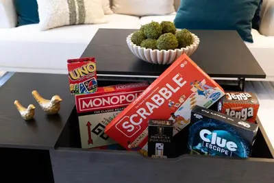 a coffee table with snacks and a bowl of broccoli at Modern 3BR Near EWR, Parking, 25 Min NYC in Kearny