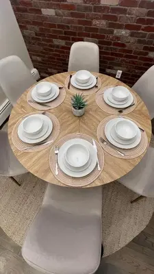 a wooden table with white plates and a plant on it at Modern 3BR Near EWR, Parking, 25 Min NYC in Kearny