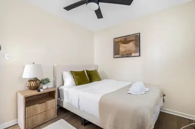 a bedroom with a bed and a ceiling fan at Modern 3BR Near EWR, Parking, 25 Min NYC in Kearny
