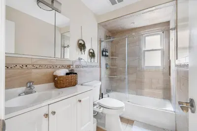 a bathroom with a toilet and a shower and a sink at Modern 3BR Near EWR, Parking, 25 Min NYC in Kearny