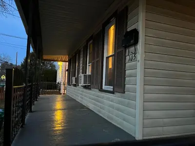 a porch of a house with a window and a sidewalk at Near East Stroudsburg University in East Stroudsburg