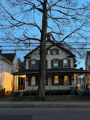 a large house with a tree in front of it at Near East Stroudsburg University in East Stroudsburg