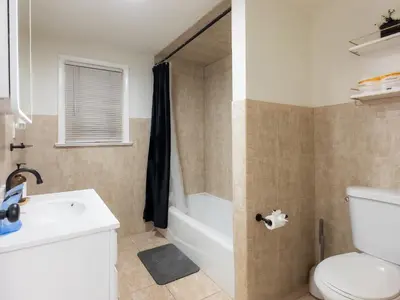a bathroom with a tub and a toilet and a sink at Elegant NYC View Stay Park Free 6 beds Sleep 8 in Kearny