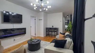 a living room with a couch and a tv at Elegant NYC View Stay Park Free 6 beds Sleep 8 in Kearny