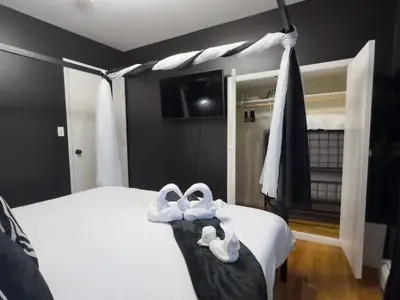 a bedroom with two white shoes on a bed at Elegant NYC View Stay Park Free 6 beds Sleep 8 in Kearny