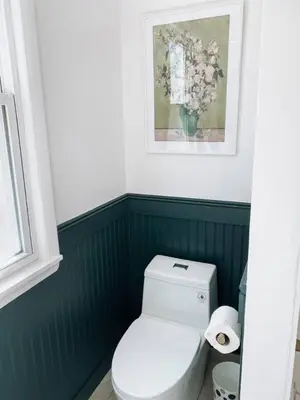 a bathroom with a toilet and a picture on the wall at Garden Oasis 3BR 23min NYC PATH in Harrison