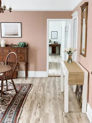 a dining room with pink walls and a wooden table at Garden Oasis 3BR 23min NYC PATH in Harrison
