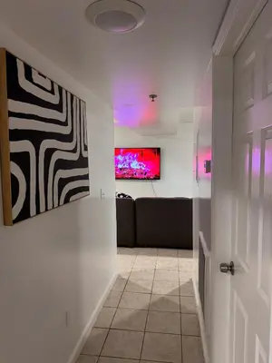 a living room with a couch and a tv on a wall at Large 2Kings 2 bedroom 2 bath by EWR NYC Downtown Newark in Newark